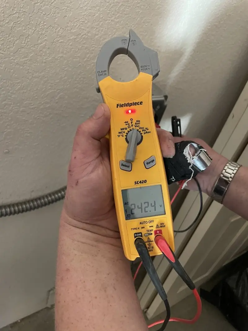 Voltage testing with clamp meter during Recessed Lighting Installation in East Grand Forks